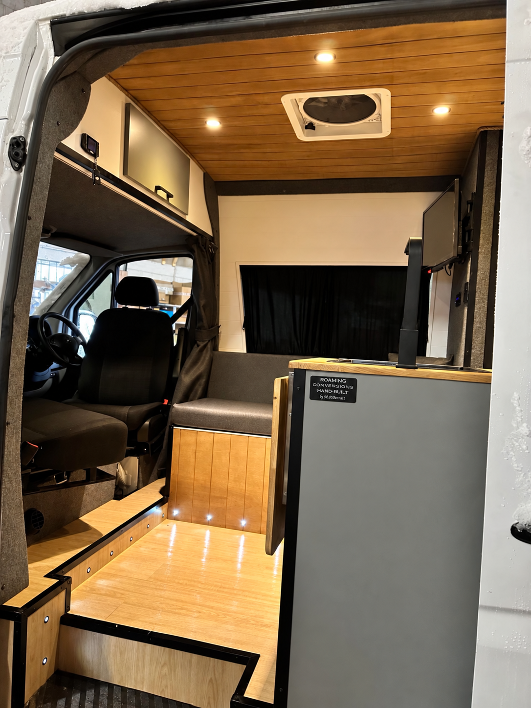 Inside Homer: the lounge, swivel seats and hand-built camper interior